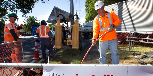 Workman pictured at work feeding ducting for the ultrafast broadband network into freshly drilled tunnel in Tauranga. Photo / NZ Herald