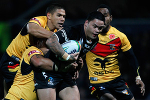 Papua New Guinea defenders wrap up Isaac Luke. Photo / Getty Images