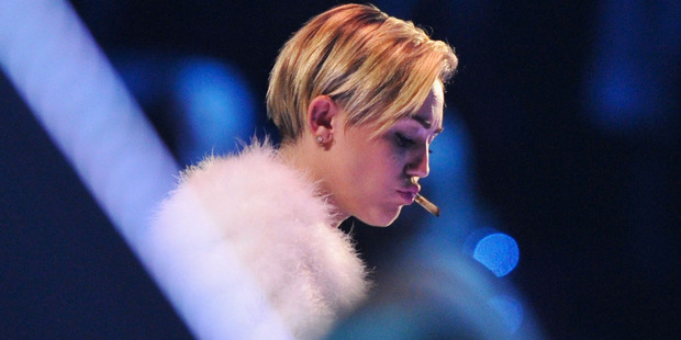 Miley Cyrus smokes a joint on stage during the MTV Europe Music Awards in Amsterdam. Photo / Getty