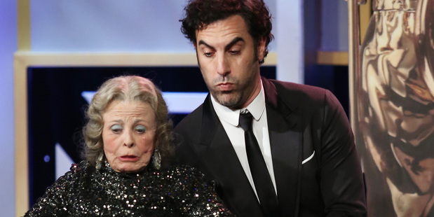 Sacha Baron Cohen pretends to fall on a presenter during the 2013 Bafta Los Angeles Britannia Awards Photo / AP