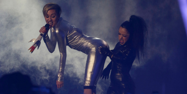 Miley Cyrus and a dancer perform at the 2013 MTV Europe Music Awards in Amsterdam. Photo / AP