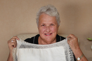Diane Wilson (above) with a worn-through linen baby's pillow case that belonged to her great grandmother Teresa. Diane's grandfather, Hugh Poland (right), was MP for Ohinemuri.Picture / Chris Gorman