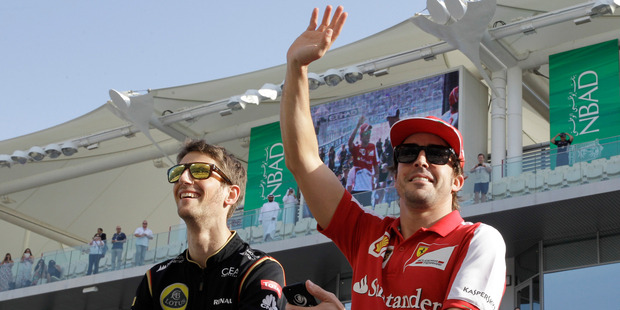 Ferrari driver Fernando Alonso (right) will be racing at the Austin, Texas Formula One round despite a back injury. Photo / AP