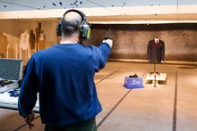 A marksman shoots a handgun at a bulletproof suit made by Garrison Bespoke tailors.
Photo / AP