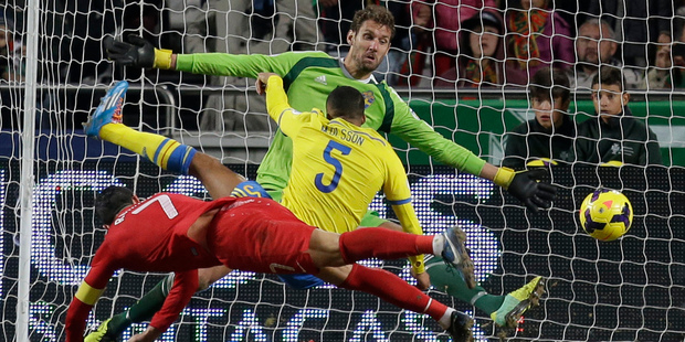 Portugal's Cristiano Ronaldo, left, scores the opening goal past Sweden goalkeeper Andreas Isaksson, background right, during the World Cup qualifying playoff first leg. Photo / AP