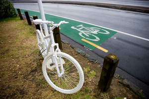 A bike painted white is parked opposite the section of road on Tamaki Drive where 27-year-old Jane Bishop died. Photo / Dean Purcell