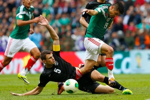 All Whites captain Tommy Smith, seen fighting for possession with Mexico's Oribe Peralta, has backed coach Ricki Herbert. Photo / AP