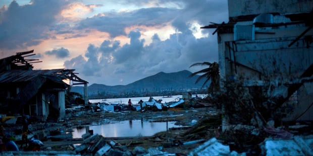 A devastated neighbourhood on the outskirts of Tacloban. Unburied bodies are causing a problem for authorities while the law and order situation is getting worse. Photo / AP