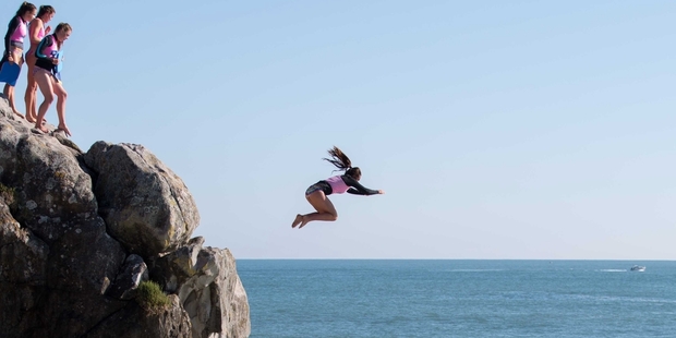 Mount Lifeguard Service member Adriana Bird leaps off the end of Moturiki Island during training at the weekend.Photo / Jamie Troughton / DSCRIBE Media Services