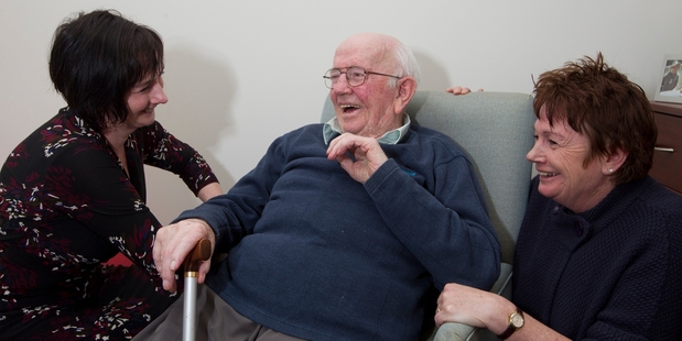 Bernie Walsh with daughters in his room at the Jean Sandel Retirement Village in New Plymouth. Photo / Mark Mitchell