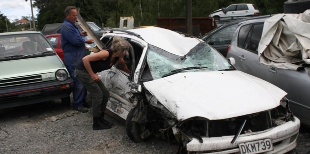 Amanda Hackett inspects the family's smashed Toyota. Photo / Mountain Scene