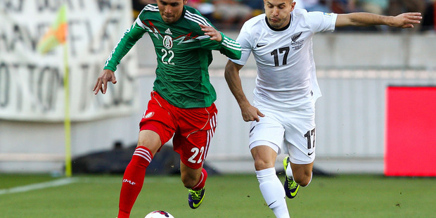 Paul Aguilar of Mexico and Kosta Barbarouses of New Zealand compete for the ball during tonight's game. Photo / Getty Images