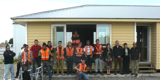 FROM SCRATCH: Nga Kanohi Marae o Wairarapa Trades Training graduates, tutors and supporters in front of the three-bedroom home students built from scratch that was sold to Martinborough buyers.