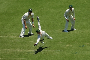 Brad Haddin dives to stop a ball down the leg side. His 94 helped salvage Australia's innings. Photo / Getty Images
