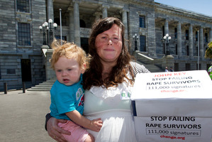 Jessie Hume, with 14-month-old Ames Hitchcock-Hume, and the 110,000-strong petition, calling for action over the Roast Busters scandal. Photo / Mark Mitchell