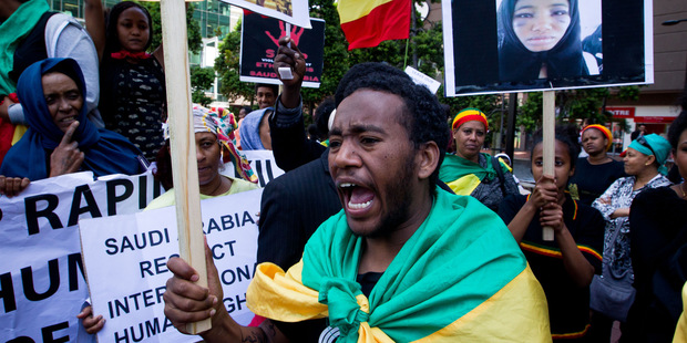 Teklay Zinaw protests alongside fellow Ethiopians in New Zealand outside the Saudi Arabian Consulate in Auckland denouncing Saudi Arabian crimes against their people. Photo / Richard Robinson