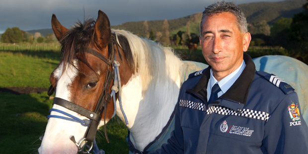 Sergeant Regan Horsfall and his horse Zoro in a paddock near the police station at Ruatoria. Photo / Mark Mitchell