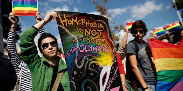 Gay activists hold rainbow flags and placards as they protest at the steps of the Acropolis' museum during an event last month. Photo / AP