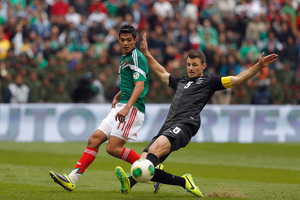 Mexico's Raul Jimenez, left, fights for the ball with New Zealand's Tommy Smith during the 2014 World Cup playoff first round soccer match in Mexico City. Photo / AP