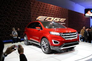 People take pictures of the new Ford Edge concept vehicle at the Los Angeles Auto Show. Photo / AP