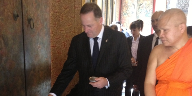 Mr Key donates coins to buy food for the monks - and bring the donor good luck. Photo / Claire Trevett