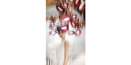 Hat - Philip Treacy, S/S 2003. Cut out mouths pop art hat, paper, silk and wire. Dress - Chalayan, S/S 1999. Cream folded pleat dress, silk. Model / Xiao Wen Ju at IMG. Photo / Nick Knight.
