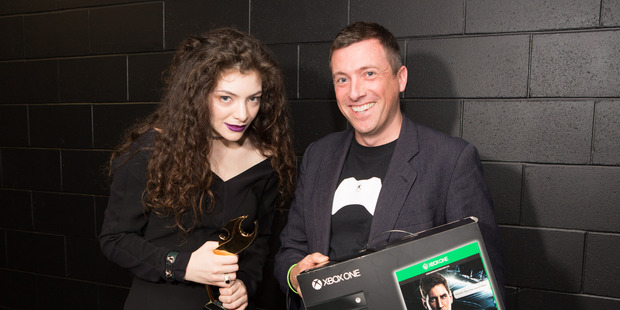 Lorde getting her Xbox One from Xbox New Zealand chief Steven Blackburn. Photo / Ollie Dale