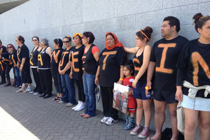 The protestors lined up outside Parliament after being ejected from the chamber. Photo / Audrey Young
