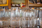 Upturned glasses at a pub counter Upturned glasses at a pub counter
