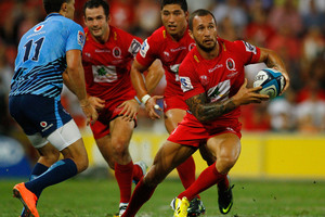Quade Cooper runs with the ball in attack during the Super Rugby match between the Reds and the Bulls. Photo / Getty Images