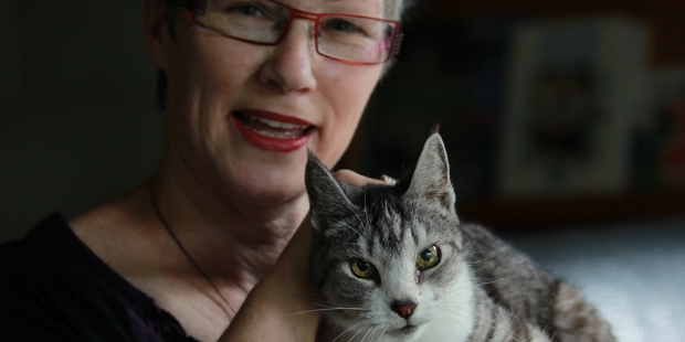 Denny McLeod with the only cat that will leave with her when she shifts from the Apata orchard. Photo/John Borren