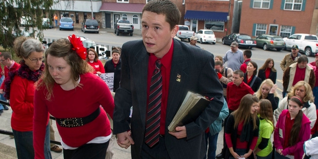 Pastor Andrew Hamblin, with his wife Elizabeth, arrives at court charged with possessing 53 venomous snakes. Photo / AP