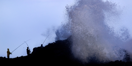Fishermen on the rocks at Piha on Auckland's West Coast.
