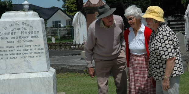 Visitors inspect the family burial plot of the Ransom family. Photo/Christine McKay.