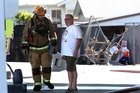 A fireman speaks to the owner of the Z energy station. Photo/John Stone. A fireman speaks to the owner of the Z energy station. Photo/John Stone.
