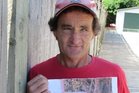 Paul McKay with a photograph he took of chicken in his letterbox. Photo/Mike Barrington. Paul McKay with a photograph he took of chicken in his letterbox. Photo/Mike Barrington.