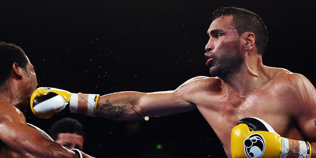 Anthony Mundine lands a right on Shane Mosley. Photo / Getty Images