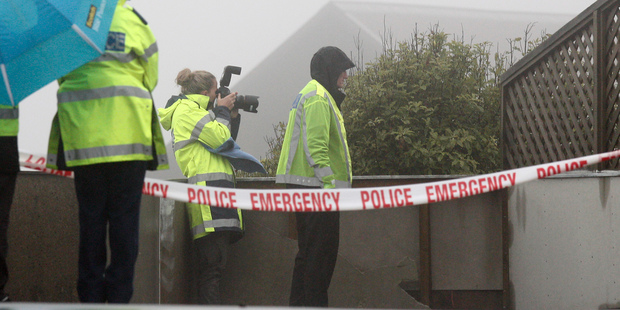 Police officers during their investigation at the Woodridge property where a woman made a desperate 111 call this morning and was later found dead. Photo / Mark Mitchell