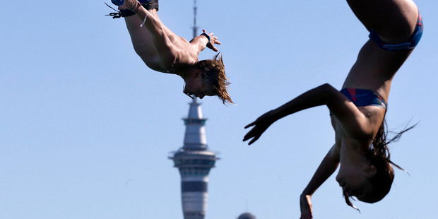 Devonport 15-year-old Hugh Raines (left) synchronises with another jumper
at Stanley Bay Wharf, across from Auckland's CBD. Photos / Brett Phibbs