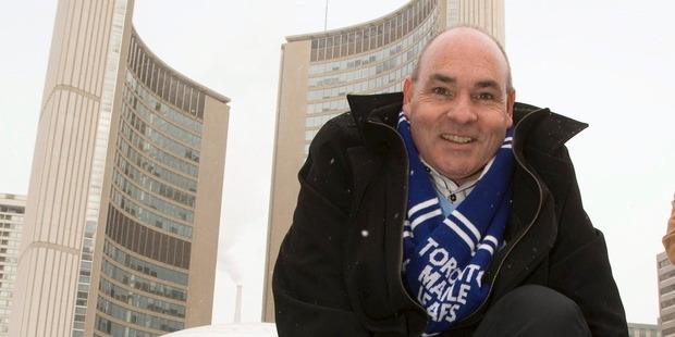 George Smitherman laces up his skates in front of City Hall after registering in the Toronto mayoral race. Photo / AP