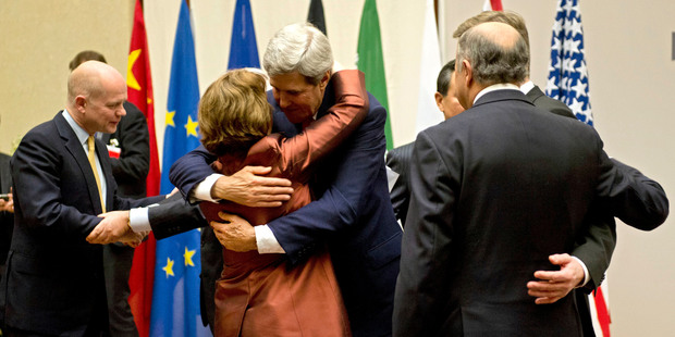 US Secretary of State John Kerry (centre) embraces EU foreign policy chief Catherine Ashton in Geneva. Photo / AP
