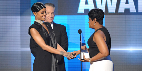 Monica Fenty, right, presents the Icon award to her daughter, Rihanna, on stage at the American Music Awards. Photo / AP