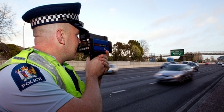 Steve Butler-Jones of the Auckland motorway police unit checks traffic speed levels with the Stalker laser gun.