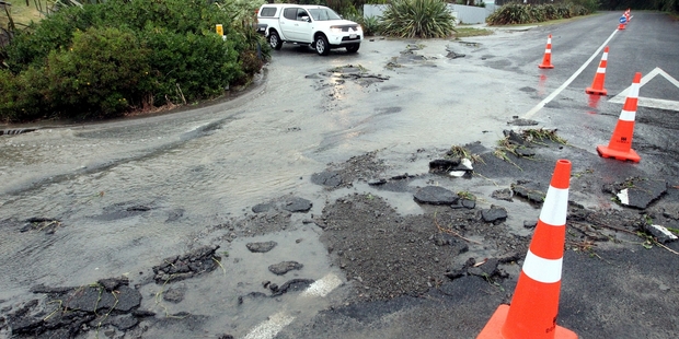 Flood water washed away a section of Kaimata Rd near Bay View last night. Photo/Paul Taylor.