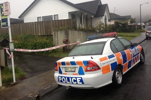 Police officers during their investigation at the Woodridge property where a woman made a desperate 111 call this morning and was later found dead. Photo / Mark Mitchell