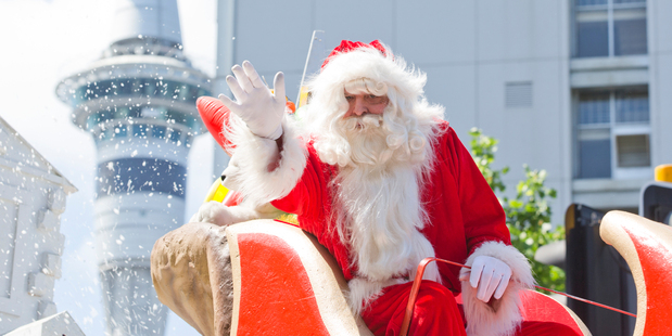 Santa waves to thousands of Aucklanders who gathered in the central city for Auckland's Farmer's Santa Parade. Photo: Greg Bowker