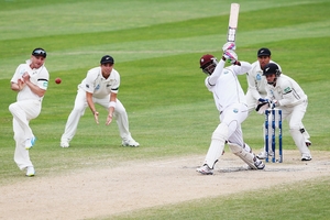 Shane Shillingford drives the ball for four runs at University Oval yesterday. Photo / Getty Images