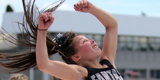 Within minutes of this photo being taken, cheerleader Grace Hegh was rushed to hospital after a wind gust lifted her mat and catapulted her several metres in the air before she crashed to the ground. Photo/John Stone.