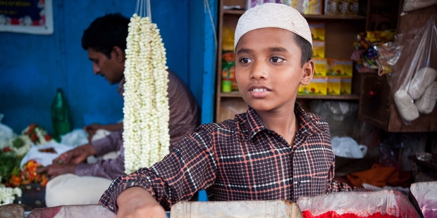 A boy stands behind a spice stall in one of India's colourful markets. Photo / Derek Cheng