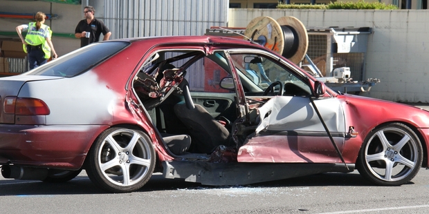 RIGHT: A fire crew had to cut off a rear passenger door to free the trapped driver.